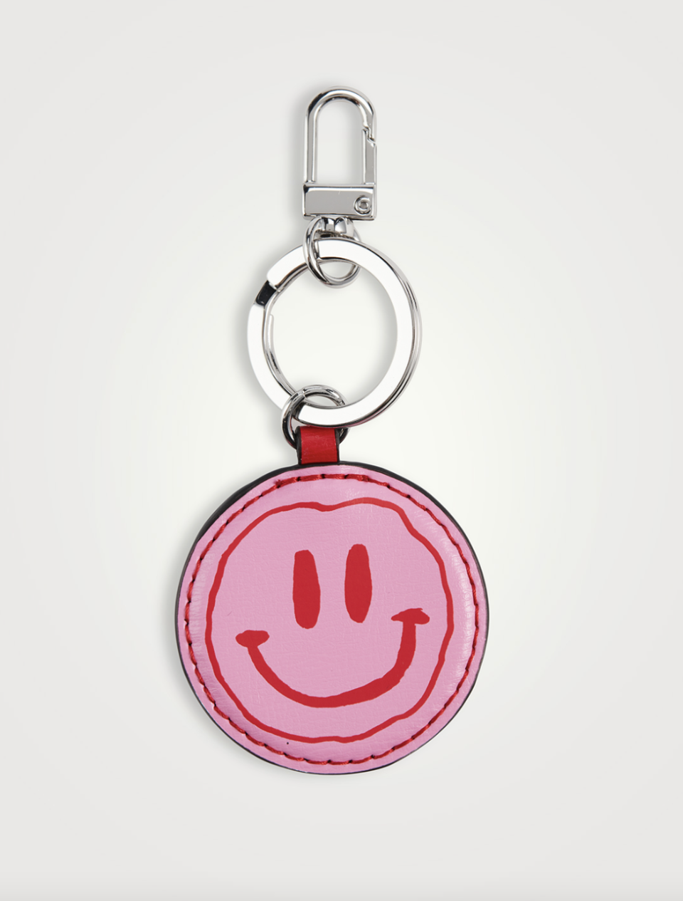 Ganni Smiley Leather Keychain in pink and red (Photo via Holt Renfrew)
