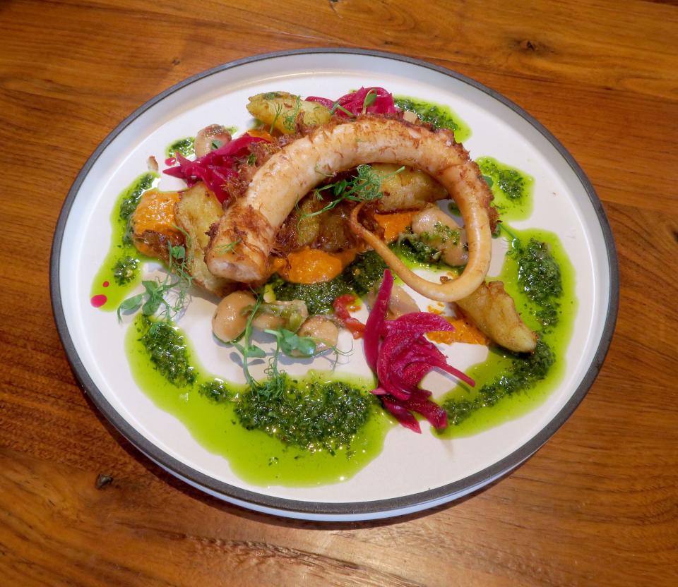 Grilled octopus with gigante beans, Yukon Gold potatoes, pickled red onions, hazelnut Romesco and salsa verde at Isola in Beach Haven.
