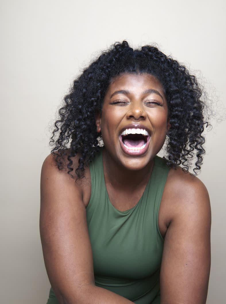 young beautiful black woman smiling against white background