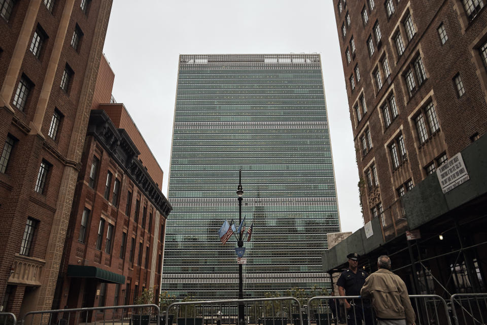 FILE - In this Sept. 18, 2017, file photo, a man talks to a police officer outside the United Nations building in New York. New York City Mayor Bill de Blasio presides over a city that's known for its skyscrapers but he is no fan of the glass towers that have transformed the Manhattan skyline in recent decades. (AP Photo/Andres Kudacki, File)