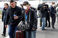 A member of the media approaches a passenger after he walked out from the cruise ship Diamond Princess in Yokohama