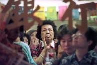 A small investor watches share prices inside a bank in Hong Kong, December 1, 1998. The 1997-98 Asian financial crisis triggered a market sell-off that led some emerging economies to impose trading controls or buy assets to calm investors. Hong Kong surprised markets with a $15 billion intervention in August 2008 to fend off speculative attacks. While Hong Kong would later have to defend its free market credentials, supporters say the intervention saved the city during the crisis. REUTERS/Larry Chan/File photo