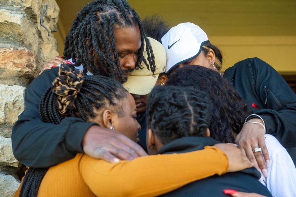 Brian Henderson, father of 12-year-old Brian Henderson Jr., who was fatally shot outside a pharmacy store in Leavenworth on April 14, 2021, hugs his wife and four daughters in a pose after speaking to The Star about his son on April 29, 2021. Brian Henderson Jr., a student at University Academy, was running errands with his sisters when he was hit by stray bullets. “He was destined to be great,” said Brian Henderson of his son.