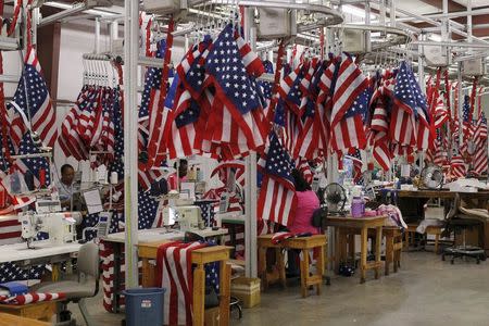 Workers sew U.S. flags at Valley Forge's manufacturing facility in Lane, South Carolina June 23, 2015. REUTERS/Brian Snyder