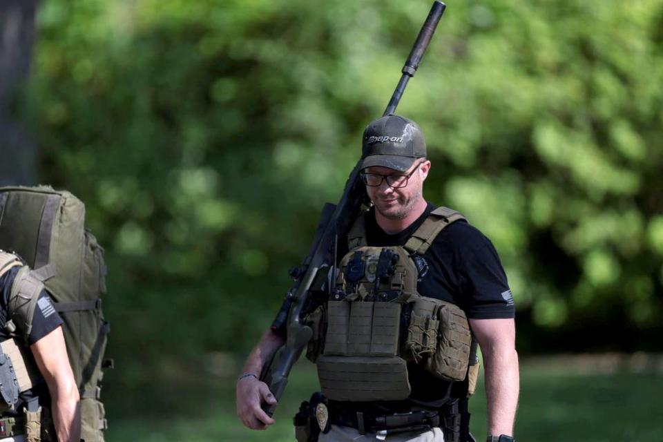 A law enforcement officer walks away from the scene at 5525 Galway Drive in Charlotte on Monday, April 29, 2024 where multiple officers were shot.