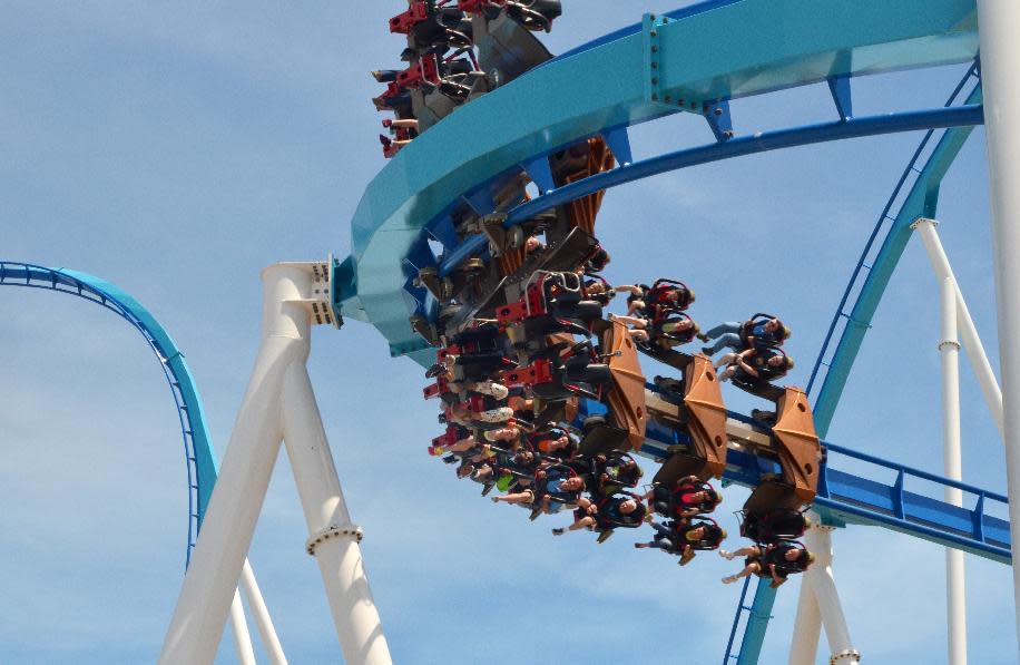 This May 9, 2013 photo released by Cedar Point shows riders testing the new, $30 million winged rollercoaster called GateKeeper at Cedar Point park in Sandusky, Ohio. GateKeeper is designed to mimic flight. It's two-minutes, 40-seconds of flips, drops and spirals. Two of the park's old rides, Disaster Transport and the Space Spiral, were taken down to make way for GateKeeper. The park opens for the season on Saturday. (AP Photo/Cedar Point)