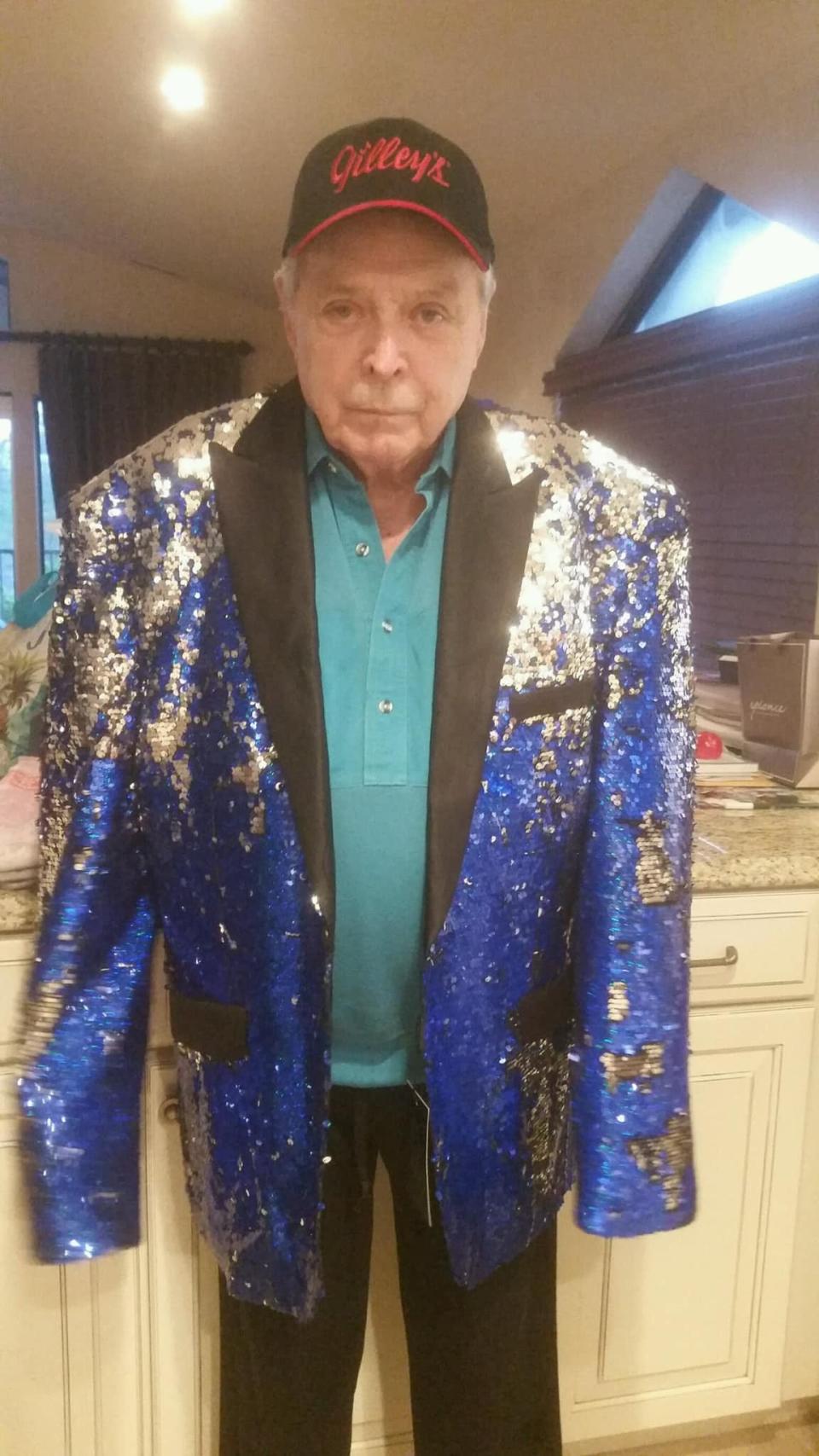 Mickey Gilley wears an oversized show jacked Mike Patrick sent him. After this gift, Gilley jokingly said, "No more."