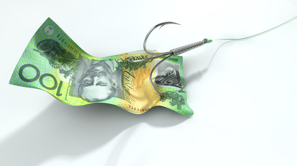 A concept image showing a one hundred australian dollar banknote used as bait attached to a treble fishhook and fishing line on an isolated white background