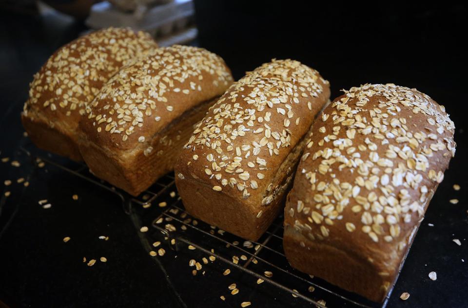 Four loaves of Peggy Koivu’s honey out bread cool on the counter of her Indianola home on Friday, Jan. 26, 2024. Koivu has made 573 loaves of bread for the Community Loaves program since December 2020.