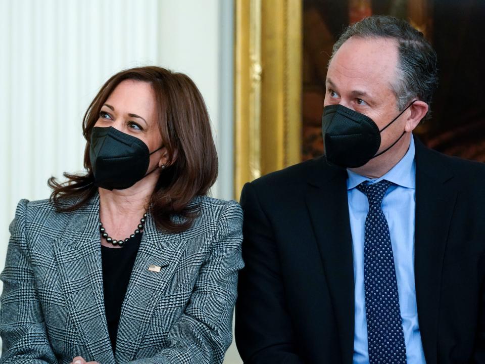 Kamala Harris and Doug Emhoff sit side by side