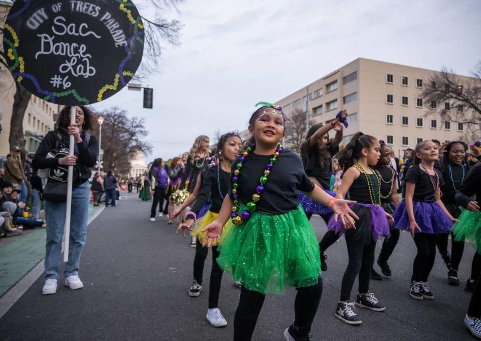 Children with Sac Dance Lab perform on Capitol Mall during the City of Trees Parade Mardi Gras procession Saturday, Feb. 18, 2023, in downtown Sacramento.