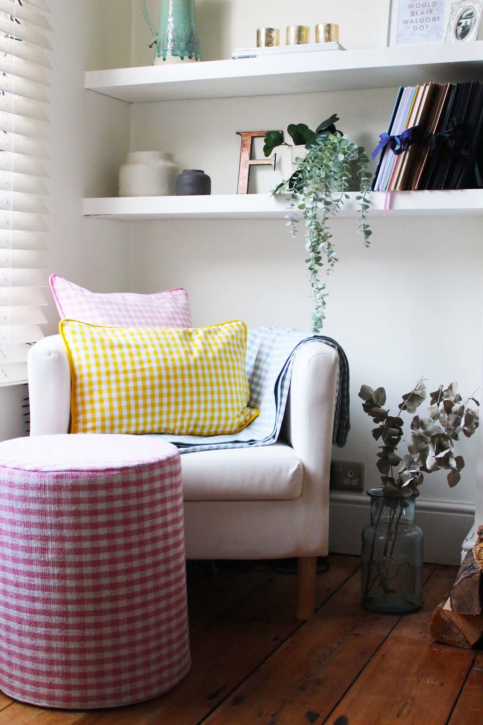 a white chair with a colorful pillow