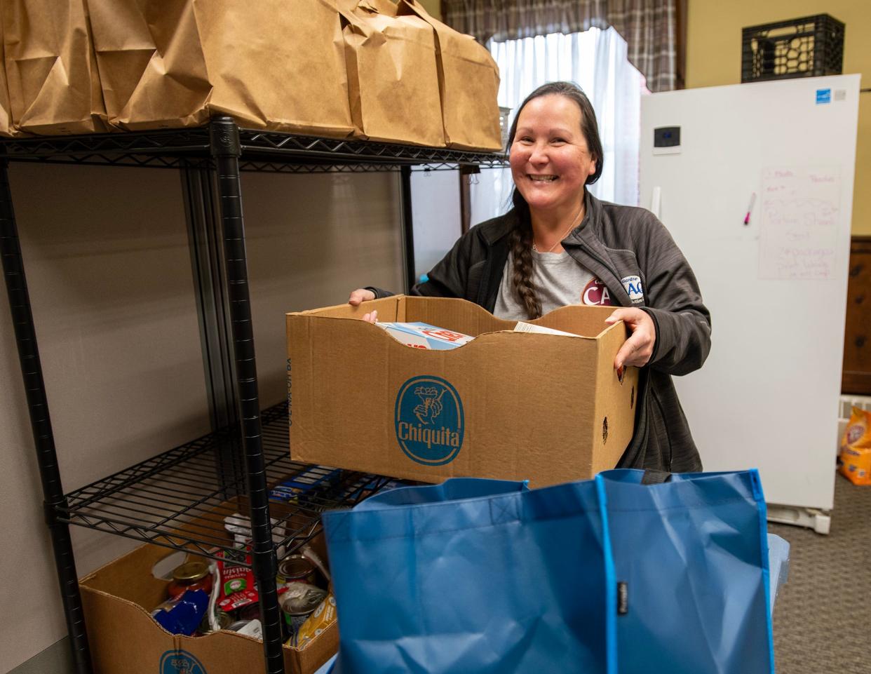 Amy LeBlanc gathers boxes of food for people arriving at the Gardner CAC food pantry Wednesday in Gardner.