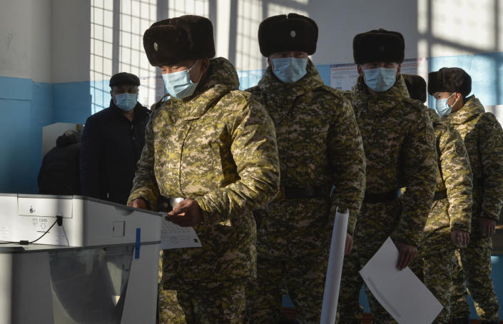 Soldiers vote during the parliamentary elections at a polling station in Besh-Kungei, 15 kilometers (9 miles) south of Bishkek, Kyrgyzstan, Sunday, Nov. 28, 2021. Voters in Kyrgyzstan cast ballots in a parliamentary election Sunday that comes just over a year after a forceful change of government in the ex-Soviet Central Asian nation. (AP Photo/Vladimir Voronin)