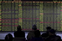 Investors look at an electronic board showing stock information at a brokerage house in Hangzhou, Zhejiang province, China, November 27, 2015. REUTERS/Stringer