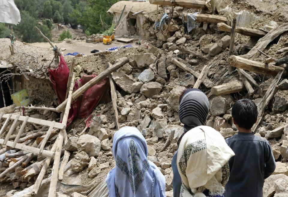 <span class="caption">Afghan children stand near a house that was destroyed in an earthquake on June 22, 2022.</span> <span class="attribution"><a class="link " href="https://newsroom.ap.org/detail/AfghanistanEarthquake/555106e793a44bf7920b910e07fc3f12/photo?boardId=37be9465fcce45d283d5431cccb20a6a&st=boards&mediaType=audio,photo,video,graphic&sortBy=&dateRange=Anytime&totalCount=293&currentItemNo=2" rel="nofollow noopener" target="_blank" data-ylk="slk:AP Photo;elm:context_link;itc:0;sec:content-canvas">AP Photo</a></span>