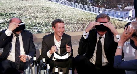 Martin Schulz, President of the European Parliament, Facebook founder and CEO Mark Zuckerberg, Mathias Doepfner, CEO of Axel Springer SE and publisher Friede Springer (L-R) try Gear VR virtual reality headsets during the awards ceremony of the newly established Axel Springer Award in Berlin, Germany, February 25, 2016. REUTERS/Kay Nietfeld/Pool