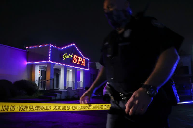 City of Atlanta Police Officer Davis works at the scene outside of Gold Spa after deadly shootings in the Atlanta area