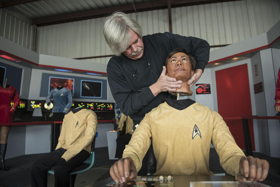 In this Saturday, March 25, 2017 photo, Steve Greenthal places the wax head of Star Trek character Sulu on its body at a hangar in the Fullerton Airport in Fullerton, Calif. Greenthal and friend Chris Liebl purchased the group of figures more than a decade ago from the old Movieland Wax Museum in Buena Park. The Hollywood Science Fiction Museum recently took possession of wax figures of all seven crew members from the 1960s "Star Trek" TV series. (Nick Agro/The Orange County Register via AP)