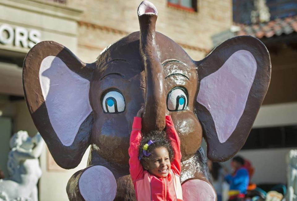 Laila Allen, 5, of Wichita, Kan., was all smiles as she played on the elephant, one of the Wonderland animals, on display along with the 9 Plaza Easter bunnies on the Country Club Plaza.