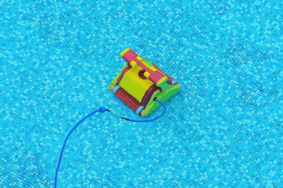 Yellow and red pool vacuum moves along the bottom of a swimming pool. 