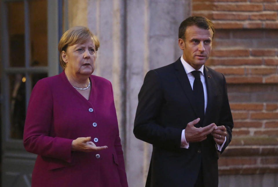 German Chancellor Angela Merkel, left, and French President Emmanuel Macron await European Commission President Ursula von der Leyen for a dinner in Toulouse, southwestern France, Wednesday, Oct.16, 2019. President Emmanuel Macron and Chancellor Angela Merkel sought Wednesday to demonstrate the solidity of the French-German relationship at a meeting in southern France, one day before a key EU summit that may approve a divorce deal with Britain.(AP Photo/Frederic Scheiber)