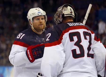 Team USA's Phil Kessel (L) congratulates goalie Jonathan Quick after defeating the Czech Republic at the end of their men's quarter-finals ice hockey game at the 2014 Sochi Winter Olympic Games February 19, 2014. REUTERS/Brian Snyder