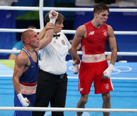 Aug 16, 2016; Rio de Janeiro, Brazil; Vladimir Nikitin (RUS, blue) reacts after defeating Michael John Conlan (IRL, red) in a men's bantamweight quarterfinal bout at Riocentro - Pavilion 6 during the Rio 2016 Summer Olympic Games. Mandatory Credit: Jason Getz-USA TODAY Sports