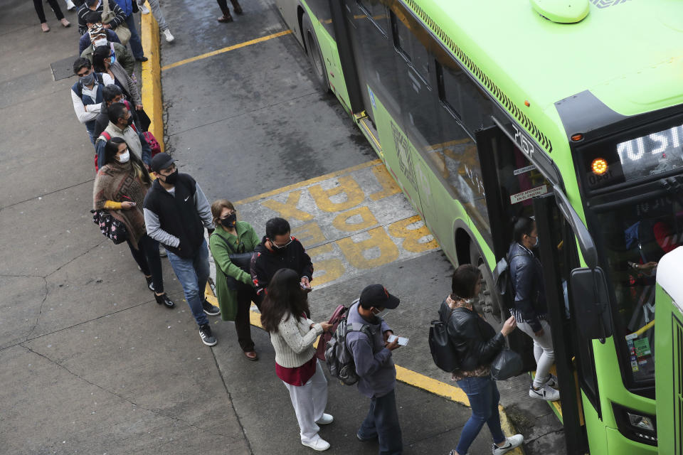 Commuters, most who use the Line 12 subway daily to get across the city, line up to board buses on the south side of Mexico City, Thursday, May 6, 2021, after a Monday collapse on Line 12 left it out of service. At its farthest point, Line 12 carries commuters from the capital’s still semi-rural south side to jobs across the city. Some 220,000 riders use Line 12 every day. (AP Photo/Marco Ugarte)