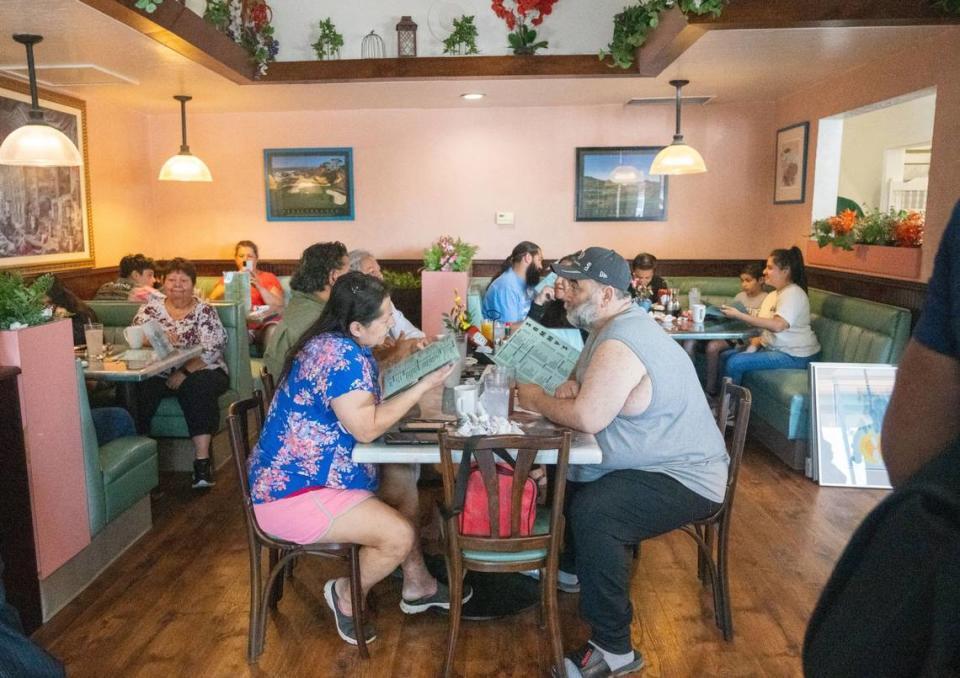 Patrons look through the menu at Sammy’s Restaurant in North Sacramento on Friday. The restaurant’s menu includes omelets, pancakes, burgers and sandwiches.