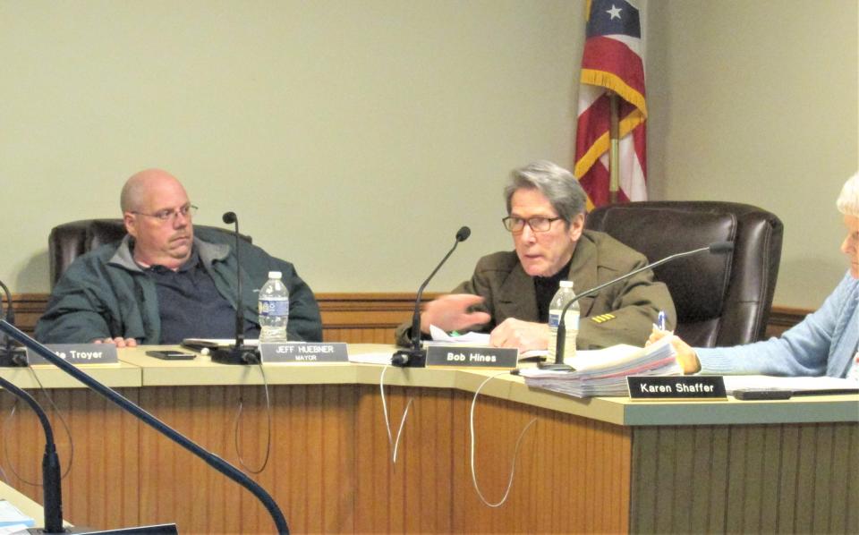 Millersburg Solicitor Bob Hines, right, discusses utility vehicles and the law with council members as Mayor Jeff Huebner looks on.