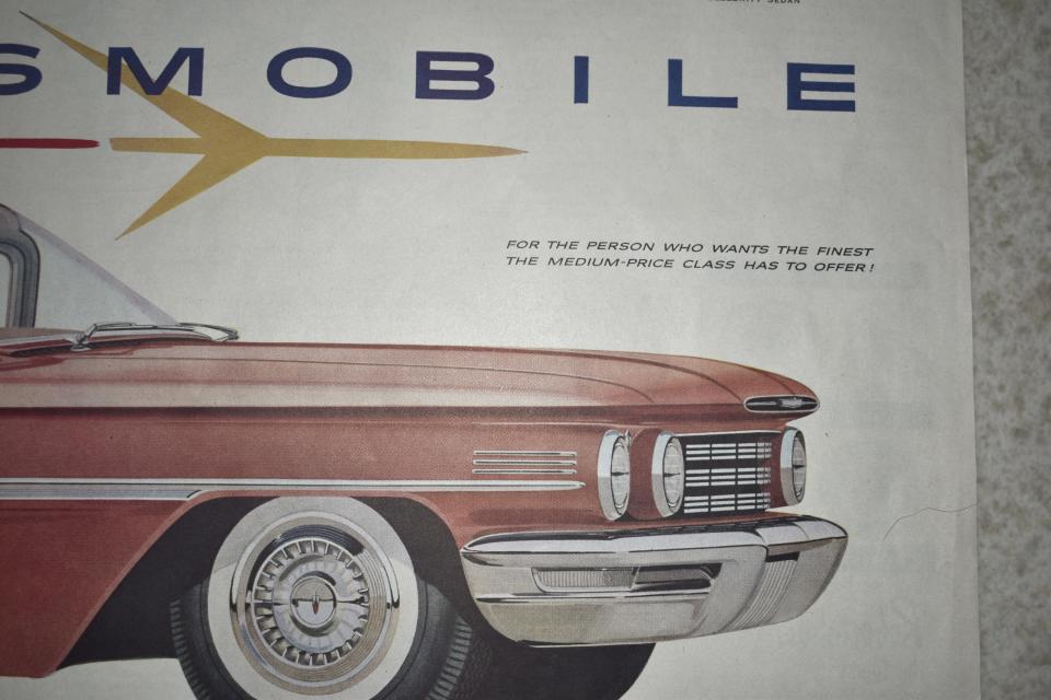 The front end of a 1960 Oldsmobile Ninety-Eight Holiday Sport Sedan pictured in a magazine ad.