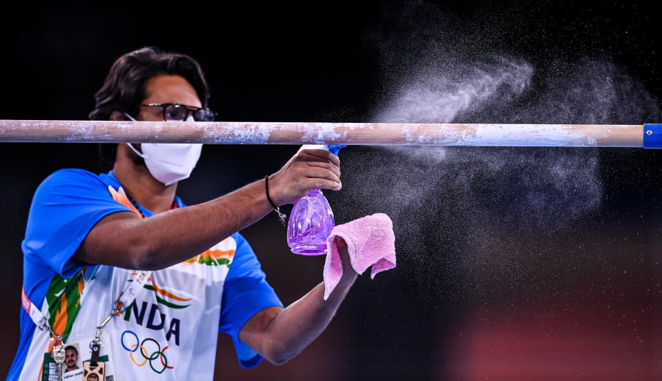 <p>India coach Lahkan Sharma sprays down the bars during a training session at the Ariake Gymnastics Arena ahead of the start of the 2020 Tokyo Summer Olympic Games in Tokyo, Japan. (Photo By Ramsey Cardy/Sportsfile via Getty Images)</p> 