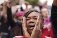 A woman speaks during a protest, Wednesday, Sept. 23, 2020, in Louisville, Ky. A grand jury has indicted one officer on criminal charges six months after Breonna Taylor was fatally shot by police in Kentucky. The jury presented its decision against fired officer Brett Hankison Wednesday to a judge in Louisville, where the shooting took place. (AP Photo/John Minchillo)