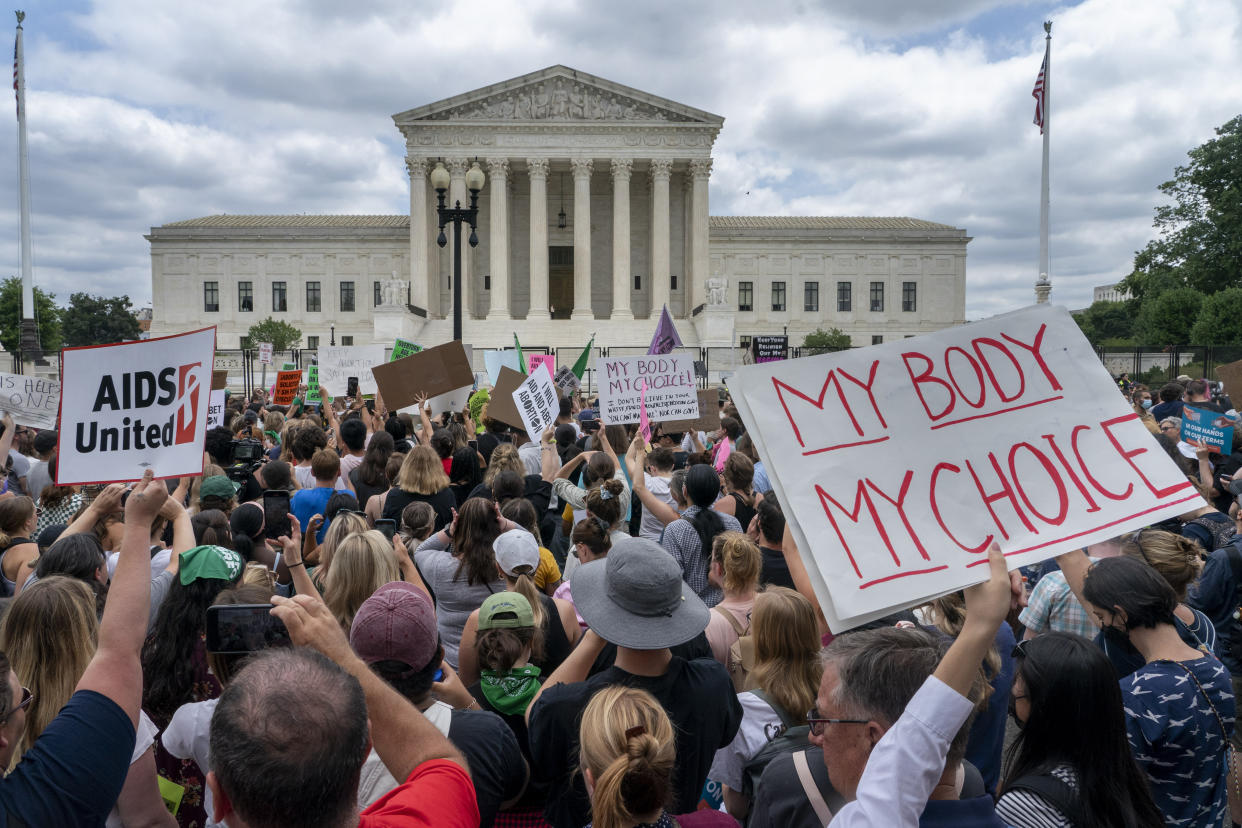 Protesters, holding signs reading, for example, 