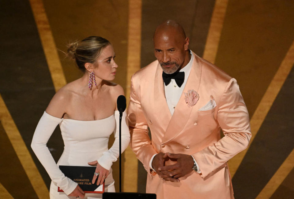 Emily Blunt and Dwayne Johnson speak onstage during the 95th Annual Academy Awards