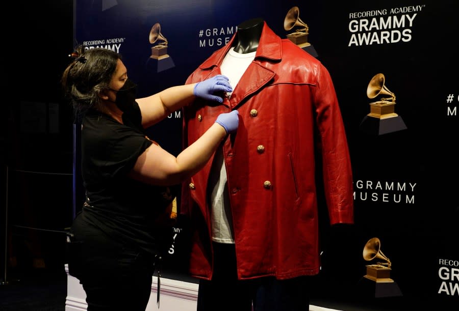 Collections assistant Cyrene Cruz primps a red leather jacket that was worn by the late rapper The Notorious B.I.G. in preparation for the exhibit “Hip-Hop America: The Mixtape,” at the Grammy Museum, Friday, Sept. 1, 2023, in Los Angeles. The Grammy Museum announced on Wednesday that it is launching the exhibit, celebrating 50 years of the genre. It will open on October 7 and run until September 4, 2024. (AP Photo/Chris Pizzello)