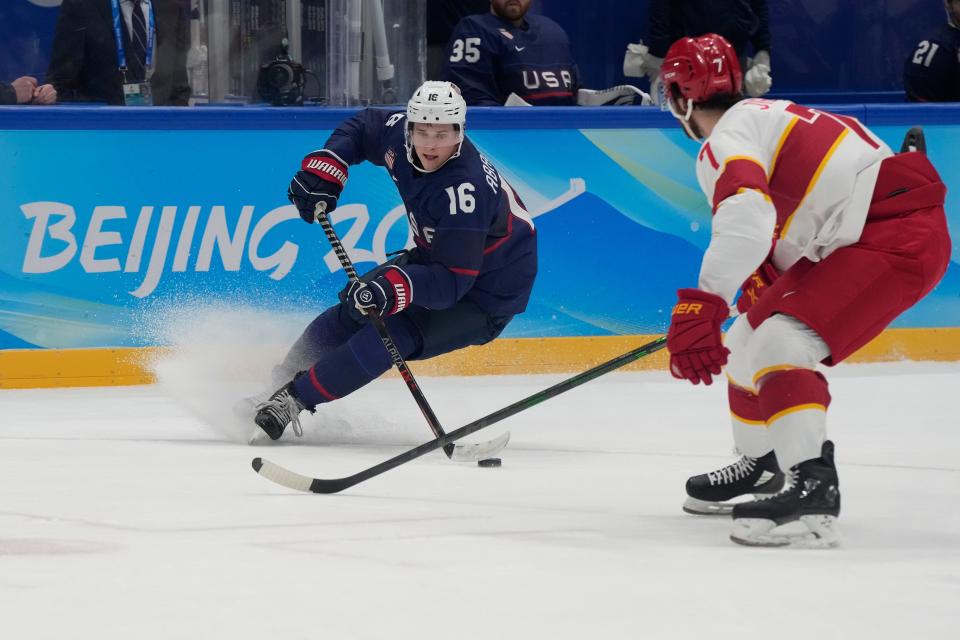 Team United States forward Nick Abruzzese (16), a Minisink Valley graduate, skates with the puck as Team China defender Kailiaosi Jieke defends during the second period during the Beijing 2022 Olympic Winter Games at National Indoor Stadium.