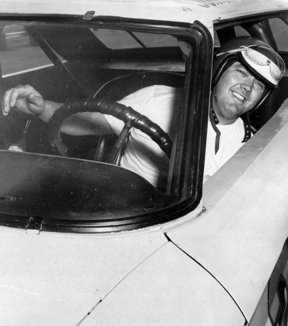 FILE - In this June 3, 1964, file photo, Junior Johnson peers from his car after winning the pole position for the Dixie 400 stock car race at Atlanta International Raceway in Atlanta. Johnson, who won 50 NASCAR Cup Series races as a driver and 132 as an owner and was part of the inaugural class inducted into the NASCAR Hall of Fame in 2010, has died at 88. (AP Photo/File)