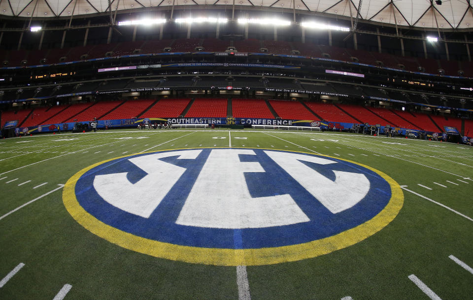 FILE - In this Dec. 5, 2014, file photo, SEC logo is displayed on the field ahead of the Southeastern Conference championship football game between Alabama and Missouri in Atlanta. Southeastern Conference chancellors and school presidents have approved revised rules on the sale of beer and wine at sporting events. The SEC's 14 schools were previously prohibited from selling alcohol in public areas at venues.  (AP Photo/John Bazemore, File)