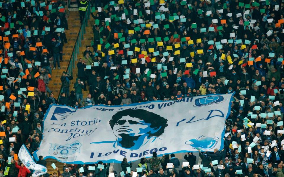 Napoli's fans deploy a giant banner showing Argentinian football star Diego Maradona before the Italian Serie A football match Napoli vs Juventus - CARLO HERMANN/AFP