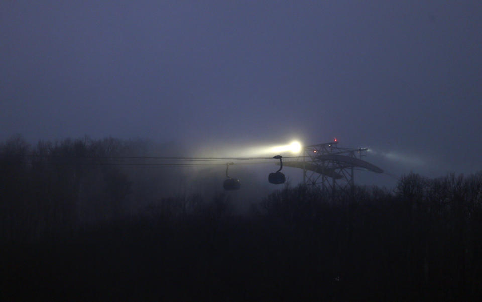 Fog rolls in over the gondola leading to the Laura Center venue and seen from the Sanki Sliding Center at the 2014 Winter Olympics, Sunday, Feb. 16, 2014, in Krasnaya Polyana, Russia. (AP Photo/Natacha Pisarenko)