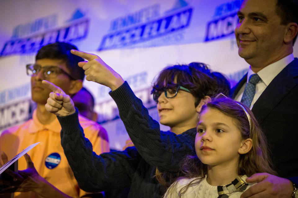 Jackson Mills points to his mom, Congresswoman-elect Jennifer McClellan as she gives a victory speech at her election party, in Richmond, Va., after winning the seat for Virginia's 4th Congressional District on Tuesday, Feb. 21, 2023. (AP Photo/John C. Clark)