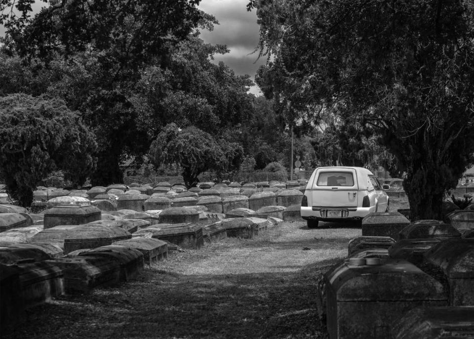 A white hearse exits Lincoln Memorial Park Cemetery in the Brownsville neighborhood.