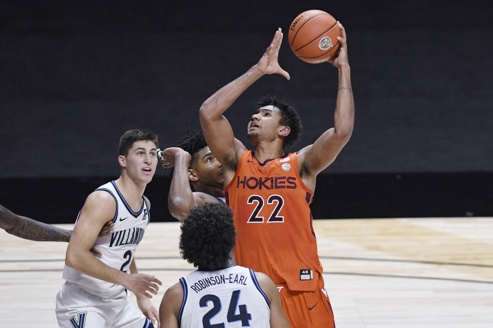 Virginia Tech's Keve Aluma, right, goes up for a shot as Villanova's Collin Gillespie, left, and Jeremiah Robinson-Earl, front, defend in overtime of an NCAA college basketball game Saturday, Nov. 28, 2020, in Uncasville, Conn. (AP Photo/Jessica Hill)