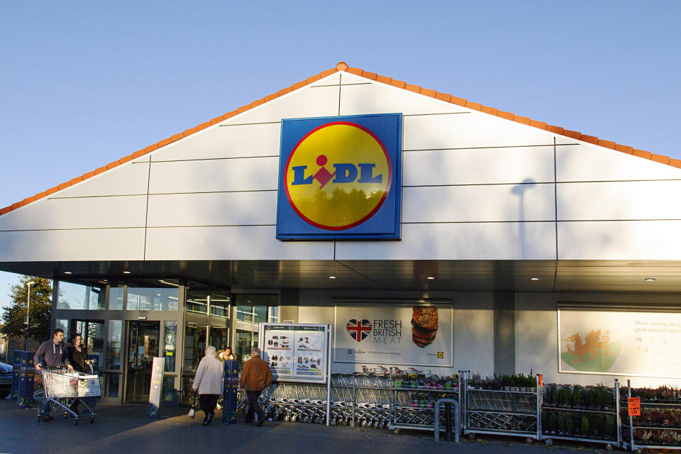 Llanelli, Wales, UK: November 07, 2016: An editorial stock photo of the Lidl supermarket in Llanelli, United Kingdom. Lidl is a German global discount supermarket chain. shoppers are entering and leaving the store with supermarket trolleys.