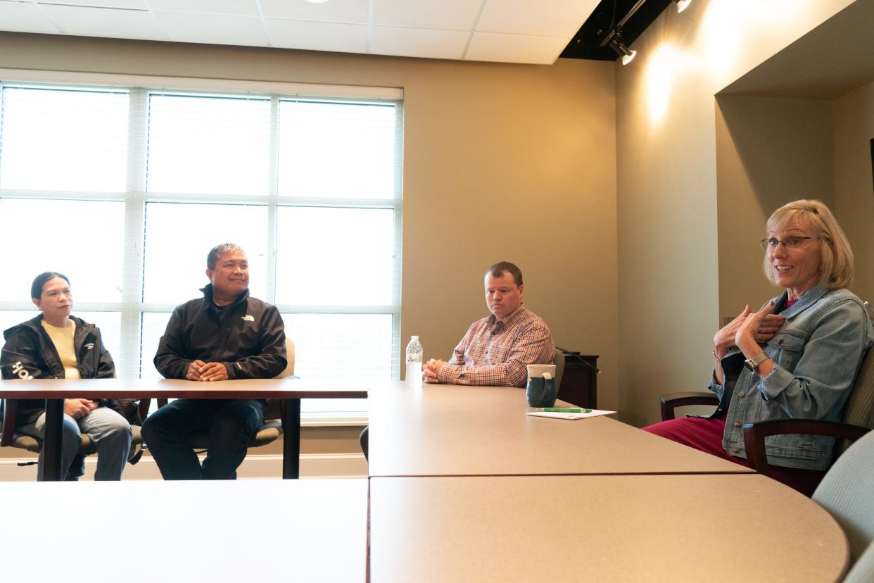 Marsha Pope, right, president of the Topeka Community Foundation, talks about why affordable housing in the area is important and how, from left, Dina and Reden Jalosjos, owners of Reden Construction and Property Management, are creating that in North Topeka. Also pictured is Ben Murphy, president of Alliance Bank.