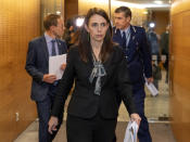 New Zealand Prime Minister Jacinda Ardern walks to a press conference in Wellington, New Zealand, Wednesday, Aug. 12, 2020. Authorities have found four cases of the coronavirus in one Auckland household from an unknown source, the first reported cases of local transmission in the country in 102 days. The news came as an unpleasant surprise and raised questions about whether the nation's general election would go ahead as planned next month. (Mark Mitchell/New Zealand Herald via AP)