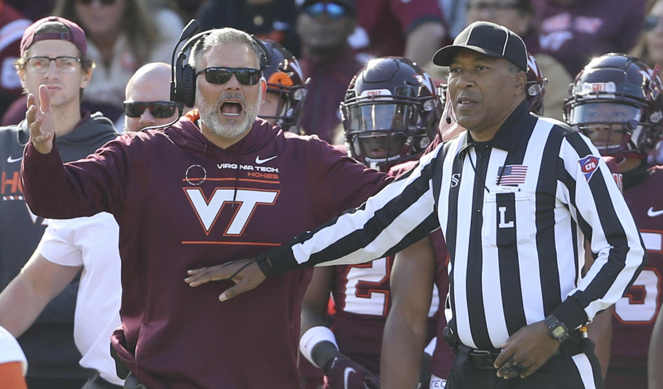 Virginia Tech head coach Justin Fuente disputes call with an official call during the second half of an NCAA college football game against Syracuse in Blacksburg Va., Saturday, Oct. 23 2021. (Matt Gentry/The Roanoke Times via AP)