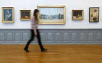 A visitor walks past Swiss painter Albert Anker's 'Kleinkinderschule auf der Kirchenfeldbruecke' (nursery school on the Kirchenfeldbruecke) (C) in the Bern Art Museum in the Swiss capital of Bern November 24, 2014. REUTERS/Ruben Sprich